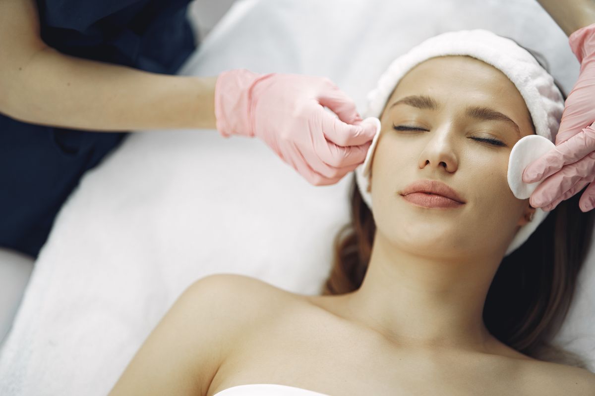 Esthetician performing a professional facial treatment at Fresh Esthetics